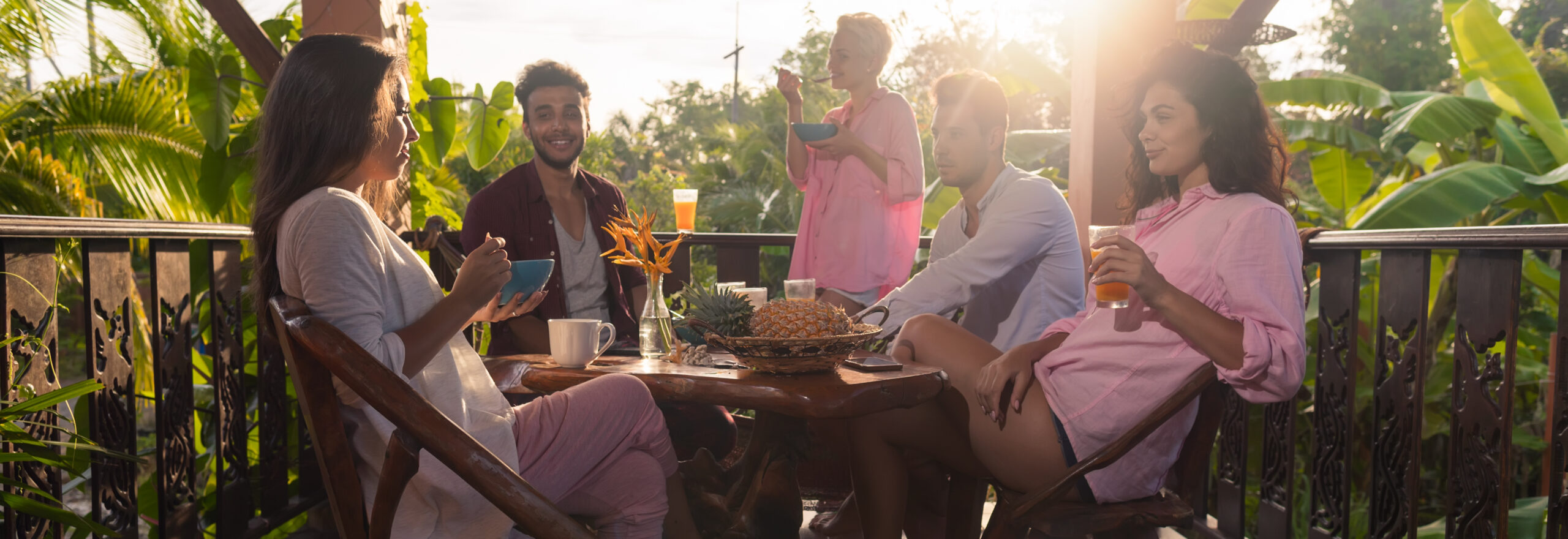 People On Summer Terrace Having Breakfast Together , Woman And Man Eat Talking In Morning Outdoors Natural Light adults eating and drinking on deck in tropics 2026 09 24 04 27 53 utc cr scaled
