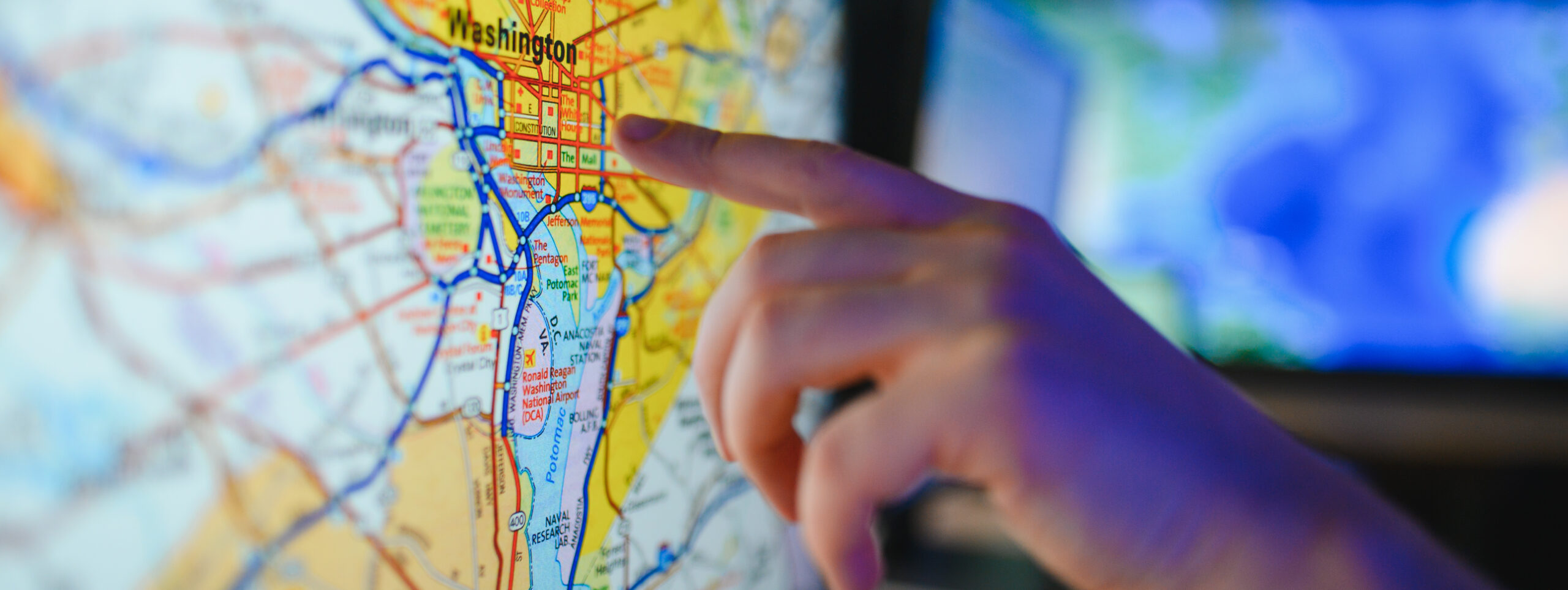 Hand touching washington dc map on screen Showing the Washington, DC map on the screen