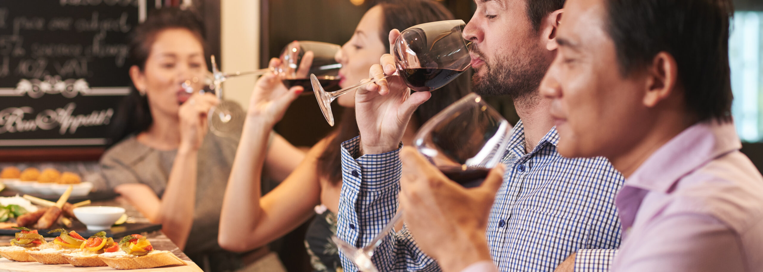 Enjoying red wine friends enjoying wine and appetizers together indo 2026 09 23 08 13 04 utc cr scaled