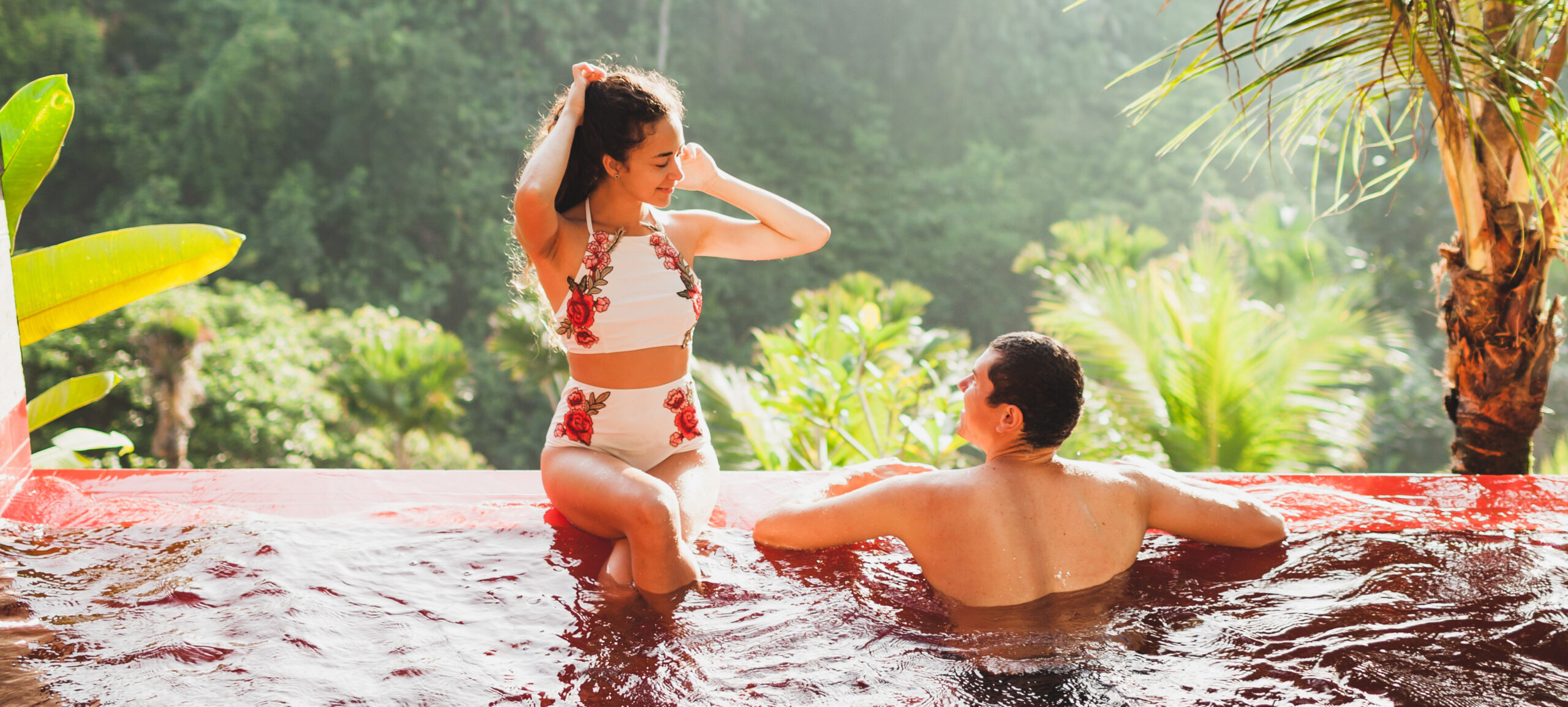 Young couple relaxing in luxury private infinity pool with amazi romantic couple relaxing in tropical paradise pool 2026 09 22 14 40 23 utc cr scaled