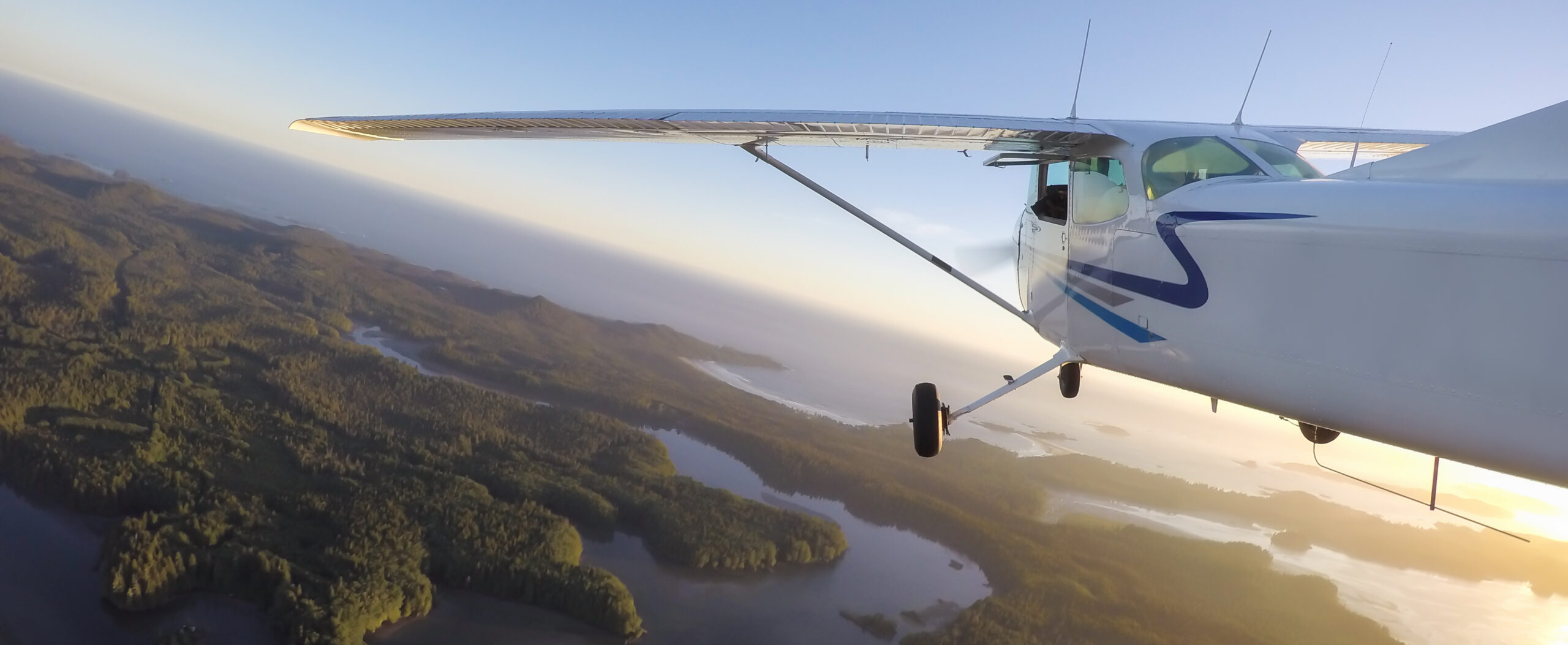 Small airplane flying around the Pacific Ocean, Vancouver Island, British Columbia, Canada.