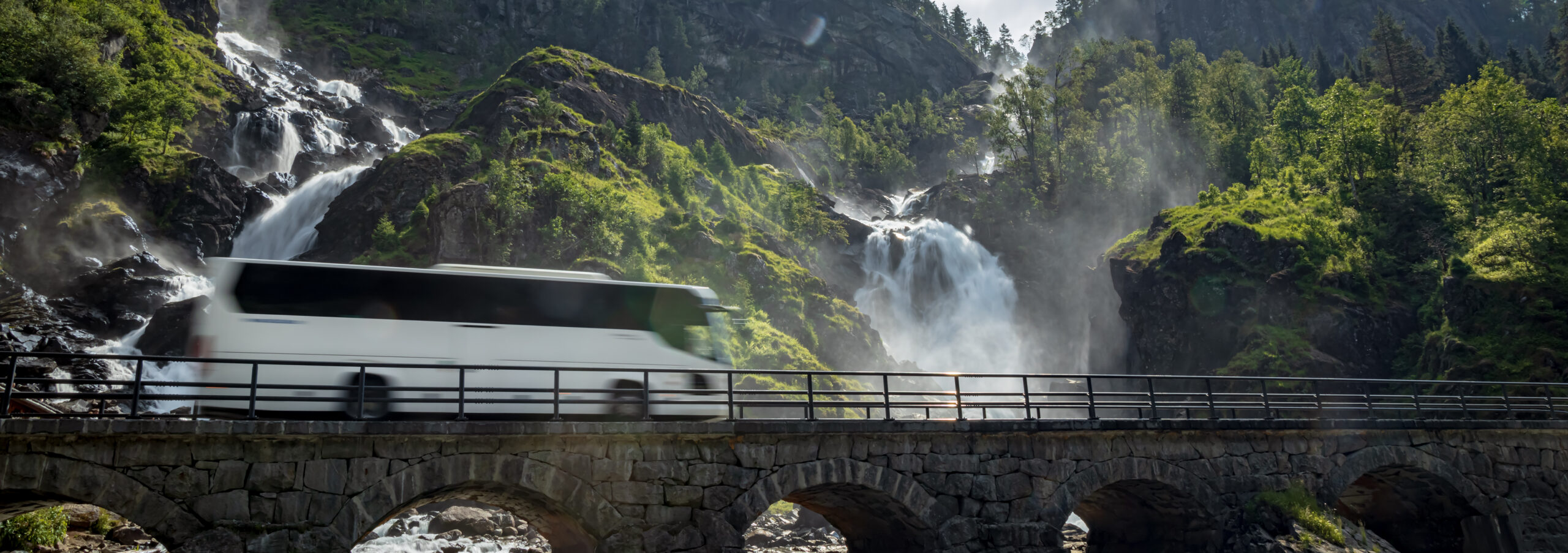 Tourist bus traveling on the road Latefossen Waterfall Odda Norw tourist bus traveling on the road latefossen water 2026 09 23 23 53 25 utc cr scaled